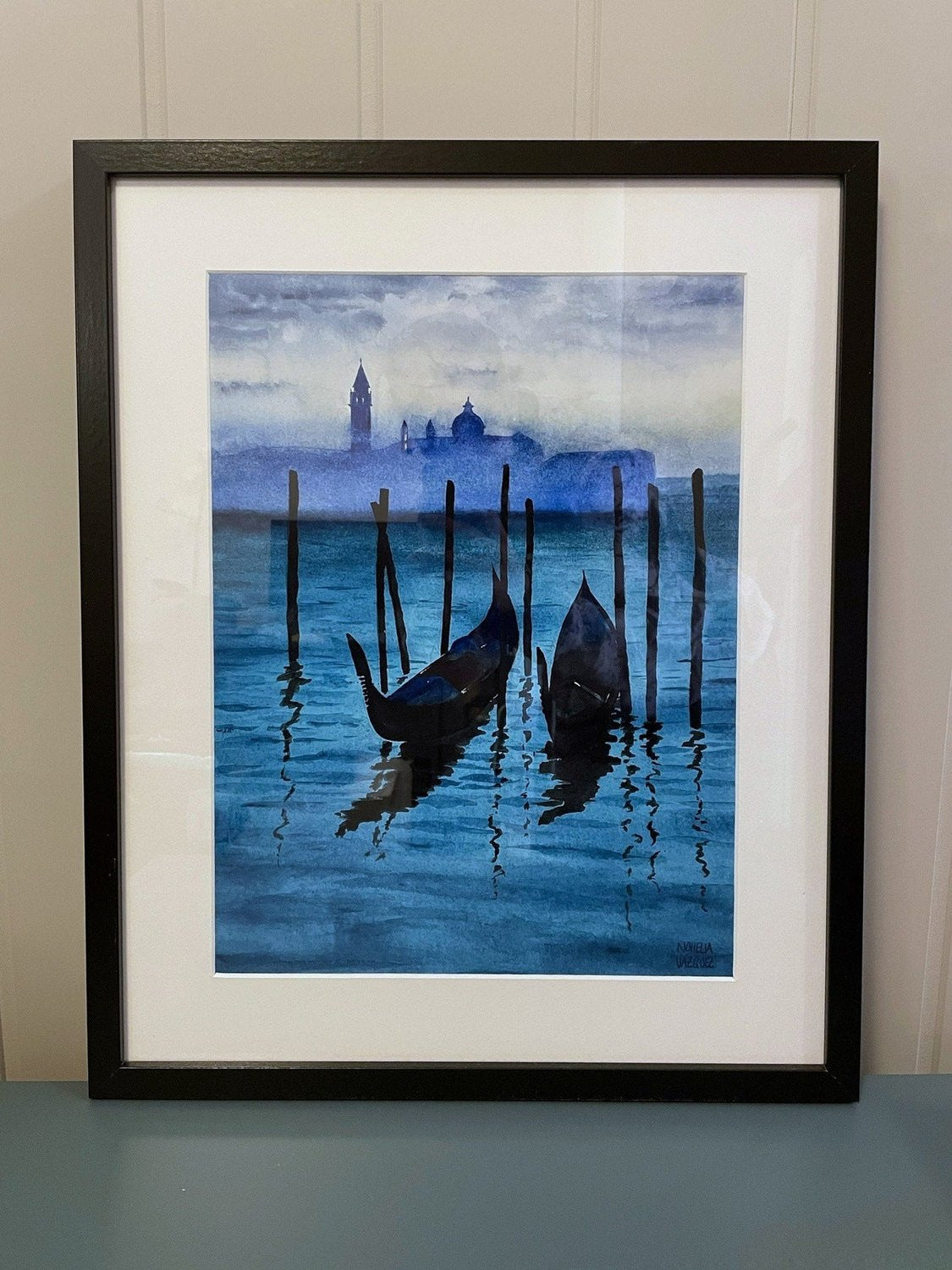 Framed Venice Gondola Watercolor Poster leaning against a wall